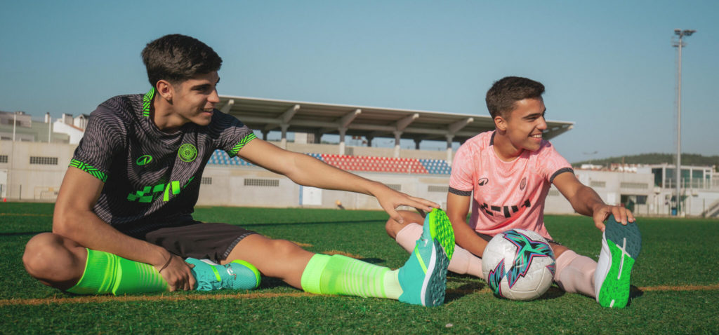 Boys stretching in custom Decathlon Club football kit.