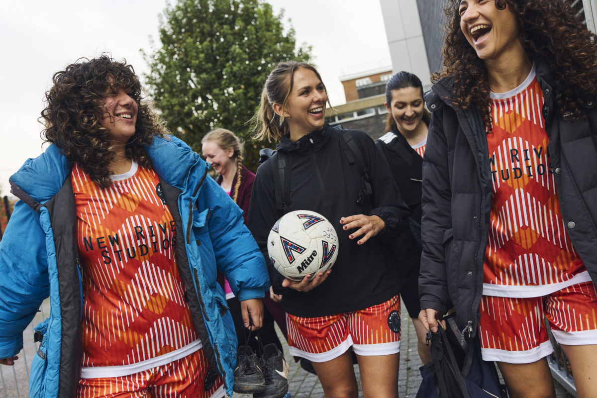 Grassroots football club players and coaches wearing matching club clothing